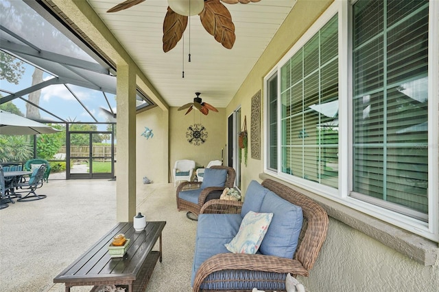 view of patio / terrace featuring glass enclosure and ceiling fan