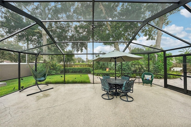 view of patio featuring a lanai