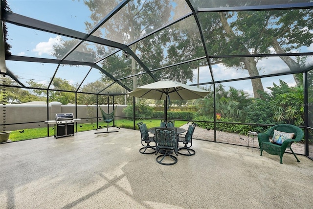 view of patio / terrace featuring glass enclosure and area for grilling