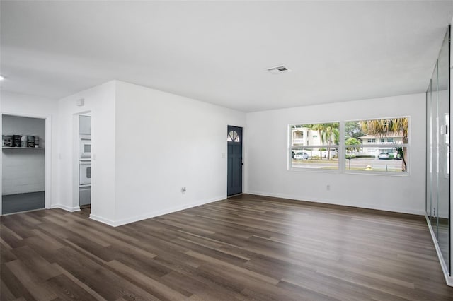 spare room featuring dark wood-type flooring