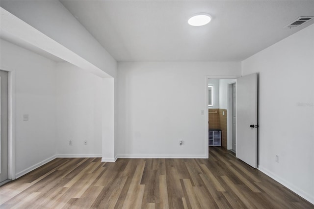 unfurnished room featuring dark wood-type flooring