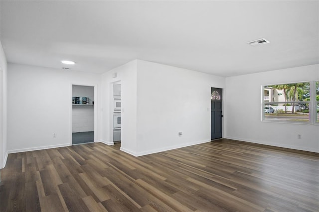 empty room featuring dark wood-type flooring