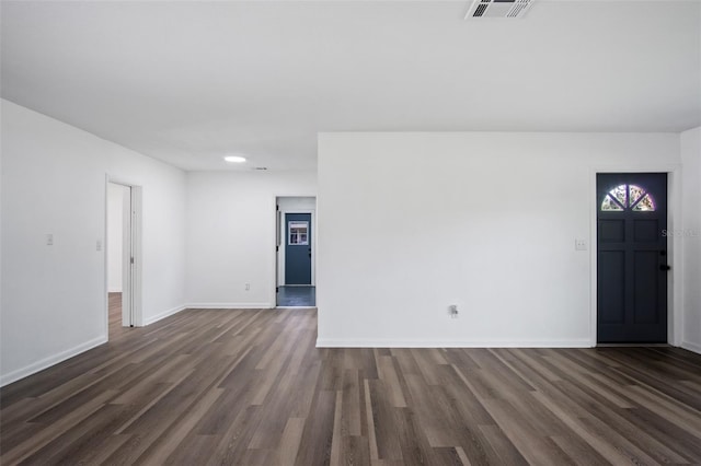 unfurnished room featuring dark wood-type flooring