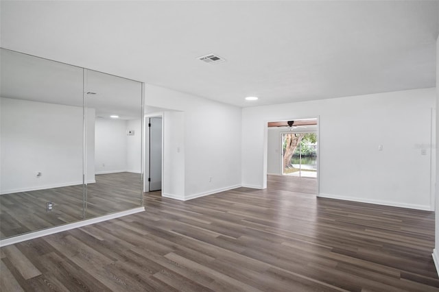 spare room featuring ceiling fan and dark hardwood / wood-style flooring