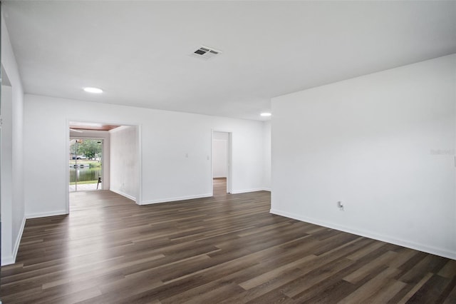 empty room featuring dark hardwood / wood-style flooring