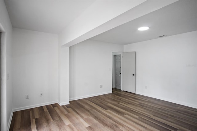 empty room featuring dark wood-type flooring