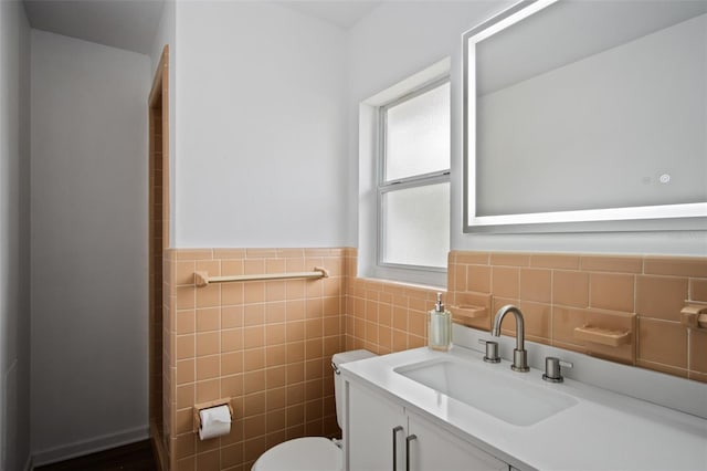 bathroom featuring tile walls, toilet, and vanity