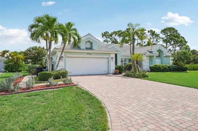 view of front of property featuring a garage and a front yard