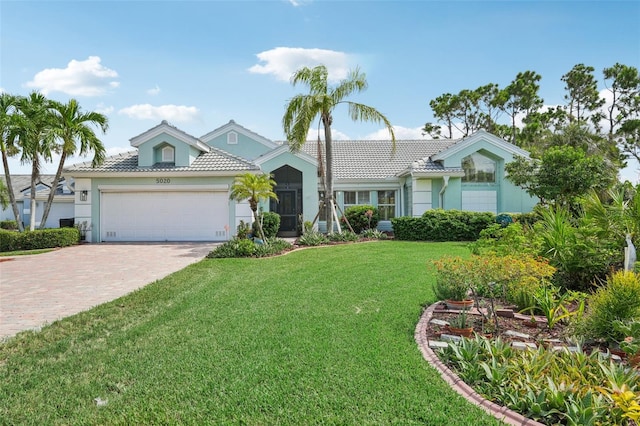 view of front facade with a garage and a front yard