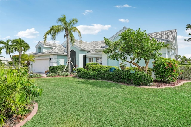 view of front of house with a garage and a front yard