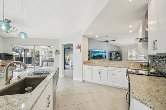 kitchen featuring pendant lighting, sink, lofted ceiling, ceiling fan, and white cabinets