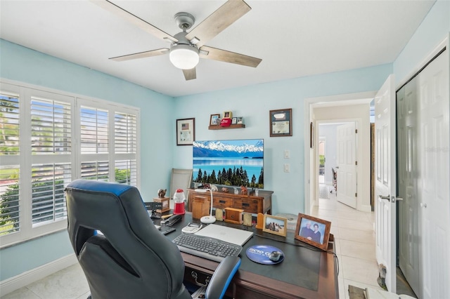 office space with light tile patterned floors and ceiling fan