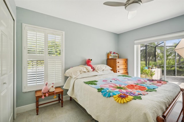 bedroom featuring multiple windows, ceiling fan, and a closet