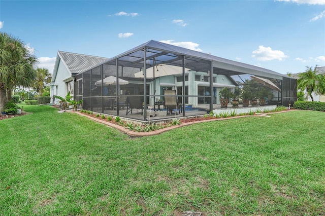 back of property featuring a yard, a lanai, and a patio area