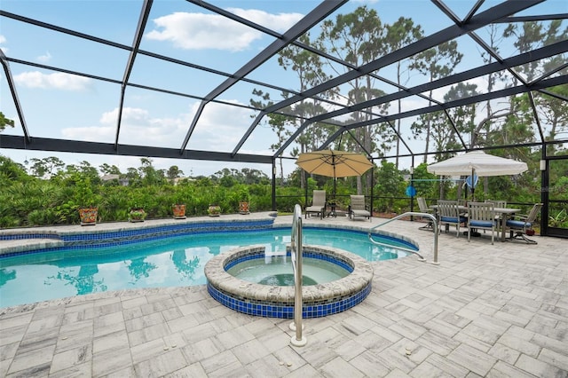 view of pool with a lanai, an in ground hot tub, and a patio