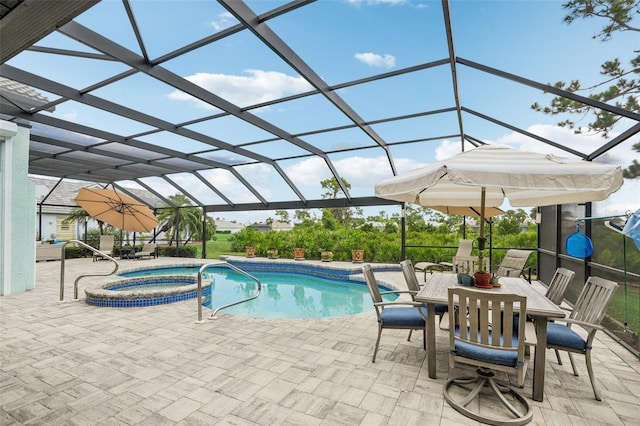 view of pool featuring a lanai, a patio area, and an in ground hot tub