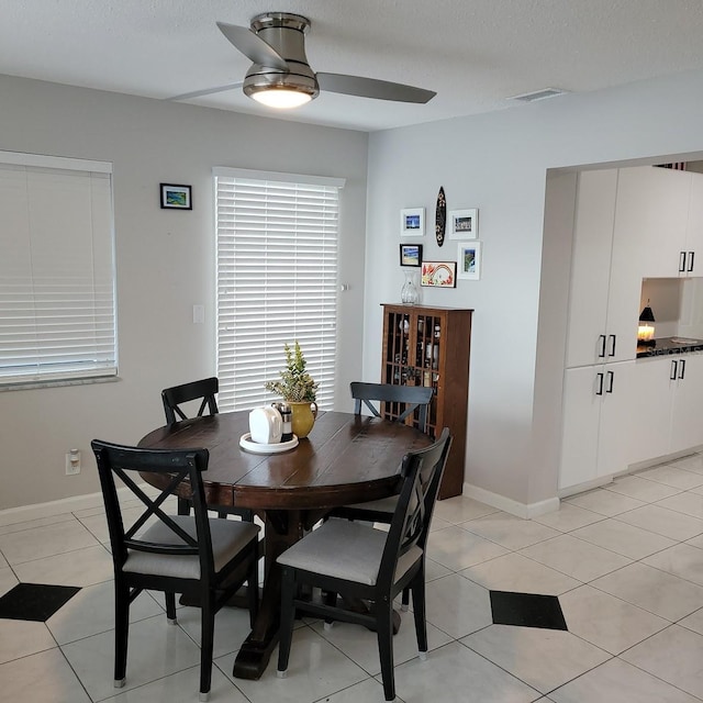 dining room featuring visible vents, baseboards, ceiling fan, a textured ceiling, and light tile patterned flooring