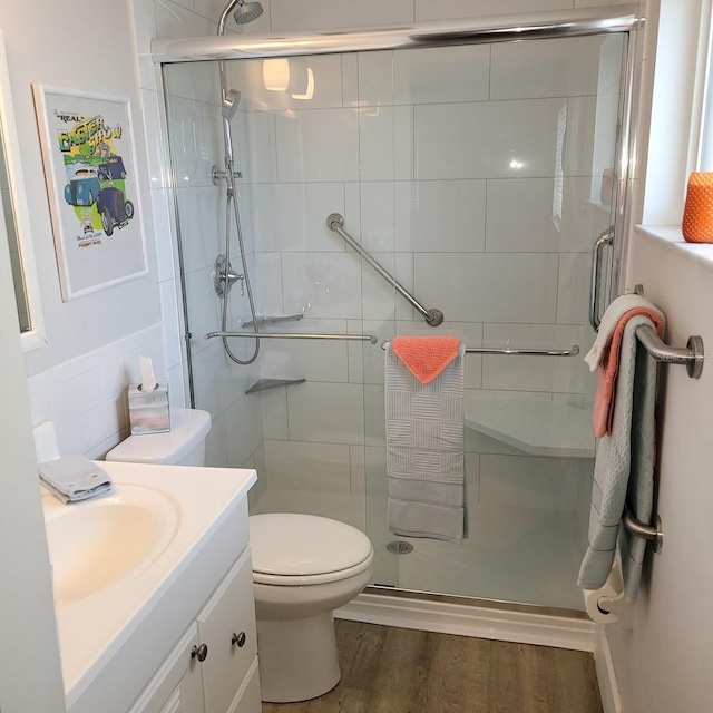 full bath with a shower stall and wood finished floors