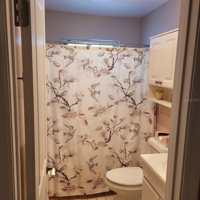 bathroom featuring curtained shower, vanity, and toilet