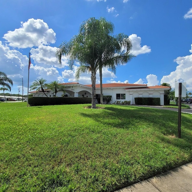 view of front of property with a front lawn and stucco siding