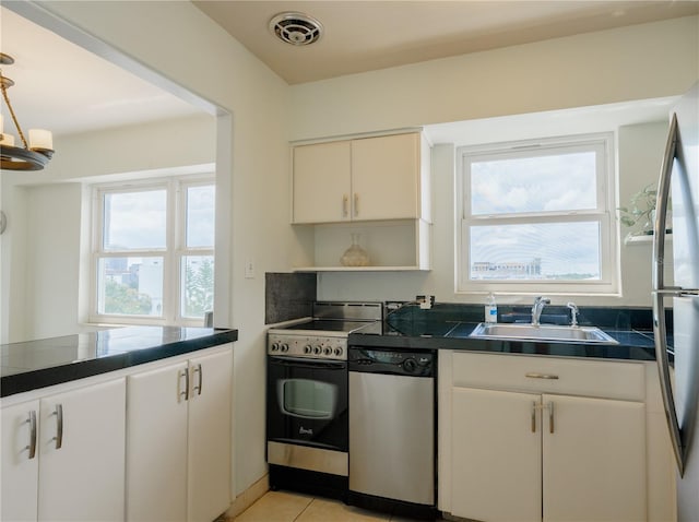 kitchen featuring sink, appliances with stainless steel finishes, and light tile patterned flooring