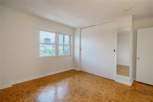 unfurnished bedroom featuring light parquet floors