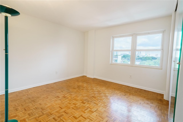 spare room with baseboards