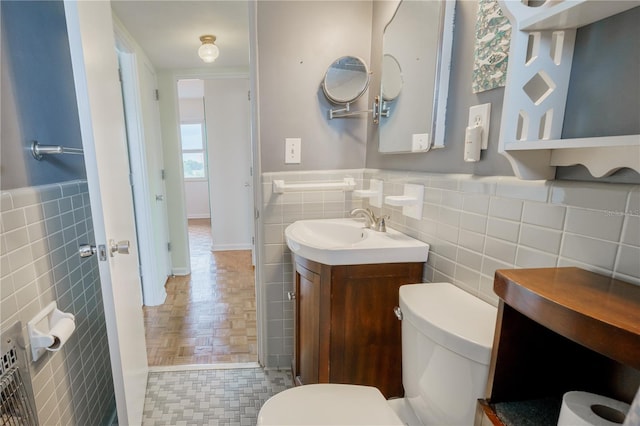 bathroom with tile walls, toilet, tasteful backsplash, and vanity