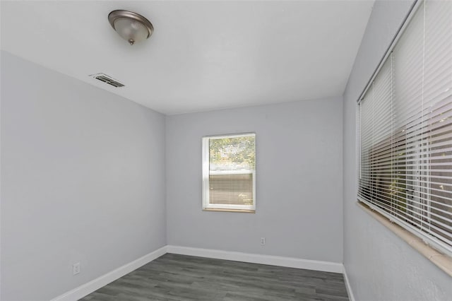 empty room featuring dark wood-type flooring