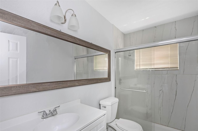 bathroom with vanity, toilet, a chandelier, and walk in shower