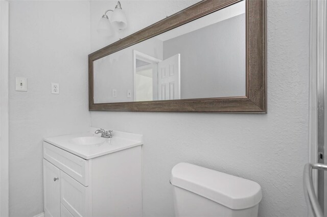 half bath with vanity and toilet