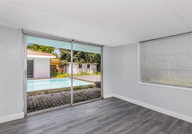 interior space with wood finished floors and baseboards