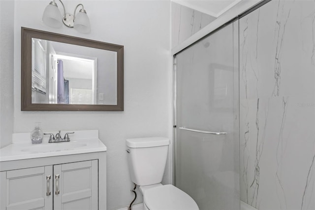 bathroom with toilet, a marble finish shower, and vanity