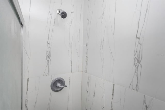 details featuring a marble finish shower