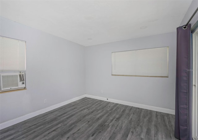 empty room with cooling unit and dark hardwood / wood-style flooring