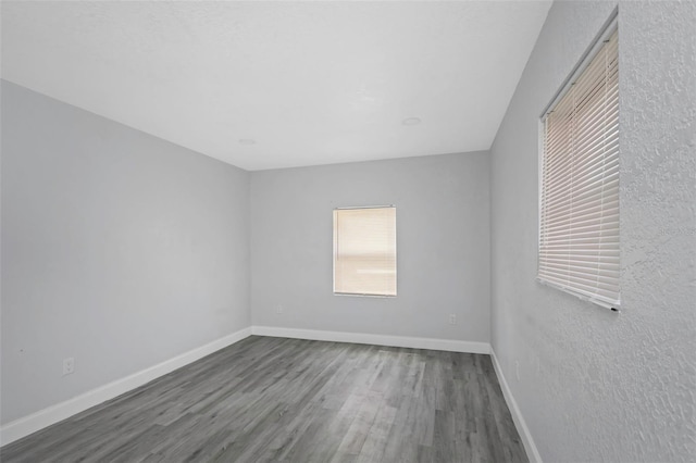 empty room with hardwood / wood-style floors