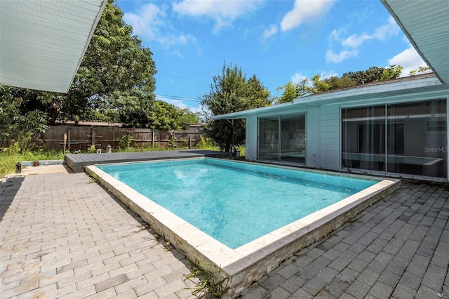 view of swimming pool featuring a fenced backyard, a fenced in pool, and a patio