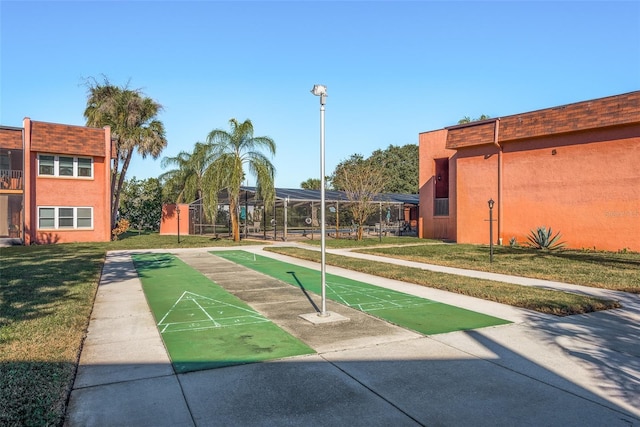 view of property's community with a yard