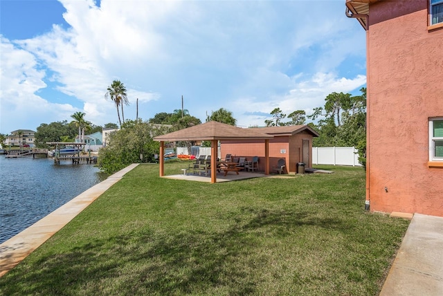 view of yard with a water view, a patio area, and a gazebo