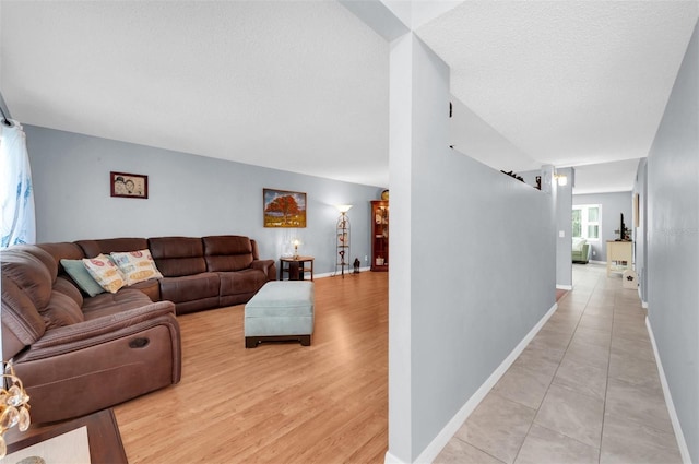 living room featuring light hardwood / wood-style floors and a textured ceiling