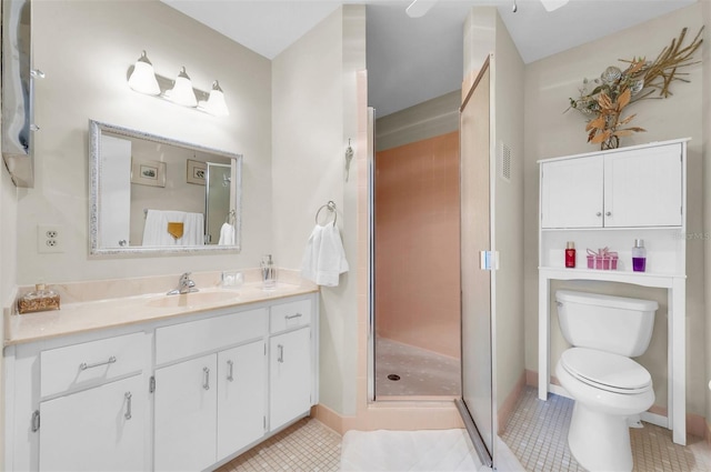 bathroom featuring vanity, toilet, tile patterned floors, and a shower with shower door