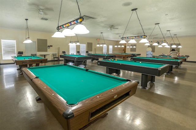 recreation room with billiards, ceiling fan, ornamental molding, and a textured ceiling