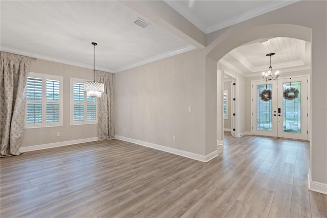 entryway featuring french doors, light wood-type flooring, crown molding, and a notable chandelier