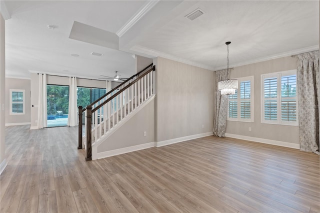 interior space with crown molding, light hardwood / wood-style flooring, and ceiling fan with notable chandelier