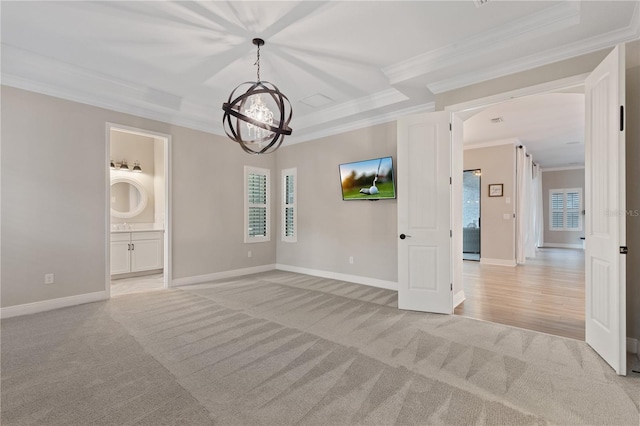 empty room with a notable chandelier, ornamental molding, and light carpet