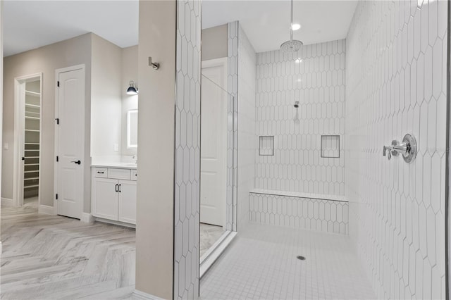 bathroom featuring vanity and an enclosed shower