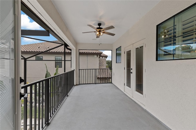 exterior space with ceiling fan and a balcony