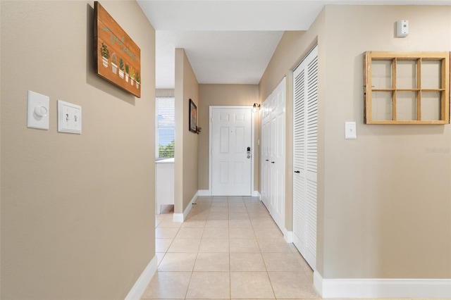 corridor featuring light tile patterned floors