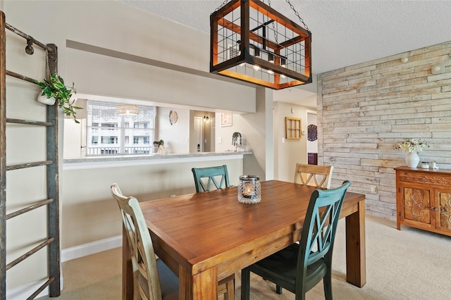 carpeted dining area featuring a textured ceiling