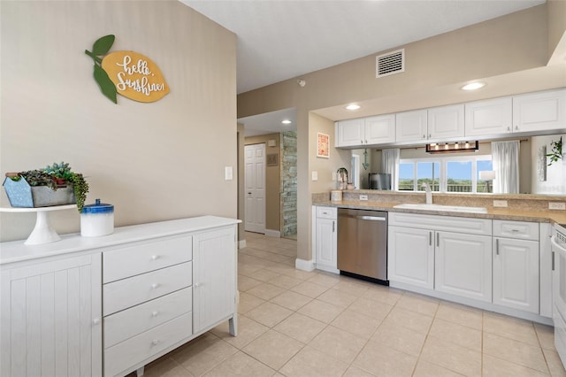 kitchen with white cabinetry, light tile patterned floors, sink, and stainless steel dishwasher